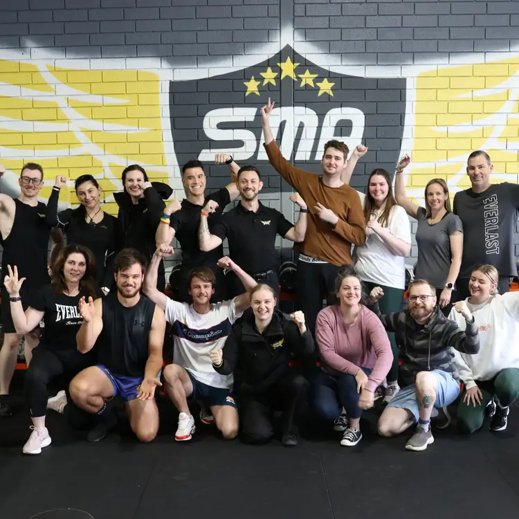 Members and coaches at Strength and Motion Academy in Midvale during a group community photo